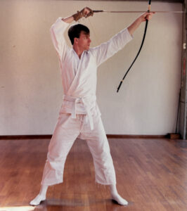 Curt holding a bow and arrow